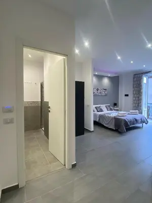 a large bedroom with a bed and a bathroom at CASE VACANZE FraEmily , PALERMO in Palermo