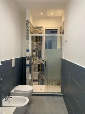 a bathroom with a shower and a toilet and a sink at CASE VACANZE FraEmily , PALERMO in Palermo