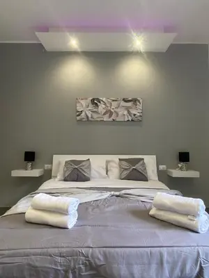 a bedroom with a large bed with two white towels on it at CASE VACANZE FraEmily , PALERMO in Palermo