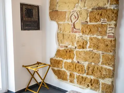 a room with a brick wall and a picture on the wall at Casa delle Maioliche in Palermo
