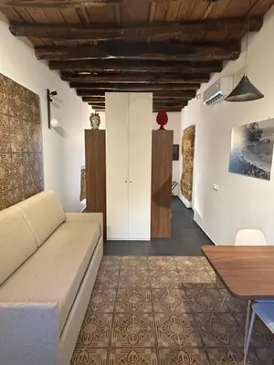 a living room with a couch and a table at Casa delle Maioliche in Palermo