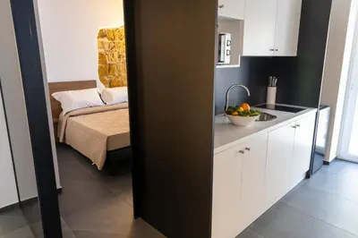 a kitchen with a sink and a couch in a room at Casa delle Maioliche in Palermo