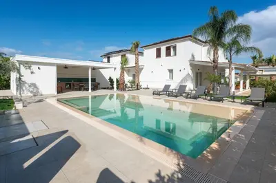 a swimming pool in front of a house at Villa Dafni Private Pool & Relax near Cefalù in Campofelice di Roccella