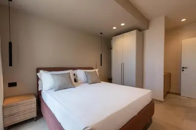 a bedroom with a large bed with white sheets and pillows at Villa Dafni Private Pool & Relax near Cefalù in Campofelice di Roccella