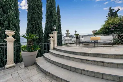 a set of stairs with benches and trees at Villa Bouganville in Monreale
