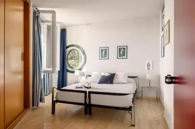 a bedroom with a white bed and a table at villa Capo Zafferano in Bagheria