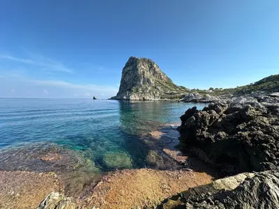 an island in the ocean with rocks in the water at villa Capo Zafferano in Bagheria