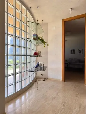 a living room with a large glass wall at villa Capo Zafferano in Bagheria