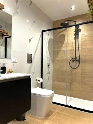a bathroom with a shower and a toilet and a sink at SILVIO'S Apartment in Castellammare del Golfo