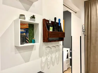 a row of wine glasses hanging on a wall at SILVIO'S Apartment in Castellammare del Golfo