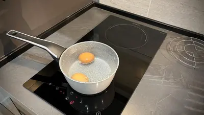 a pot on a stove with an egg in it at SILVIO'S Apartment in Castellammare del Golfo