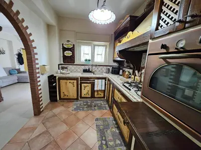 a kitchen with a stove and a tv in it at La Casa Di Ady in Palermo