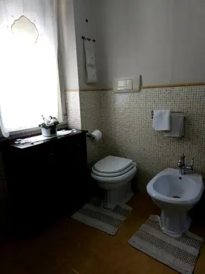 a bathroom with a toilet and a sink at La Casa Di Ady in Palermo