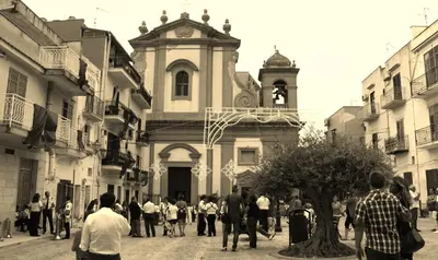 a group of people walking in front of a church at Bovio guest House in Castellammare del Golfo