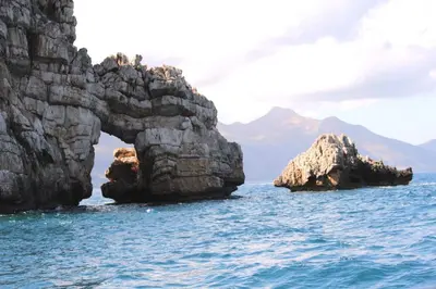 an arch in the rocks in the water at Bovio guest House in Castellammare del Golfo