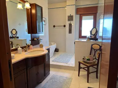 a bathroom with a tub and a sink and a bath tub at Appartamento Vista Golfo in Castellammare del Golfo