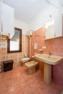 a bathroom with a sink and a toilet at Appartamento vista mare in Castellammare del Golfo