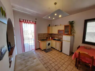 a kitchen with a table and a counter top at Appartamento vista mare in Castellammare del Golfo