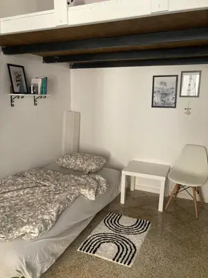 a bedroom with two beds and a table and a chair at Casteldaccia Stay, mieszkanko Kingi in Casteldaccia