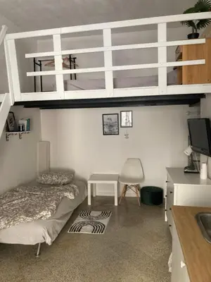 a bedroom with two bunk beds and a desk at Casteldaccia Stay, mieszkanko Kingi in Casteldaccia