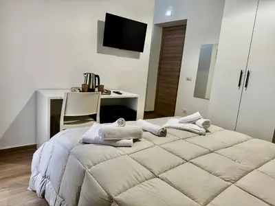 a bedroom with a bed with towels on it at Regina Rooms in Palermo