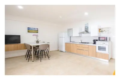 a kitchen with a table and chairs in a room at Battigia SOLEMAR-Alcamo Marina in Alcamo Marina