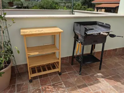 a grill and a table next to a grill at Villa with private pool and wonderful view in Carini