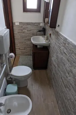 a bathroom with a toilet and a sink at Villa with private pool and wonderful view in Carini