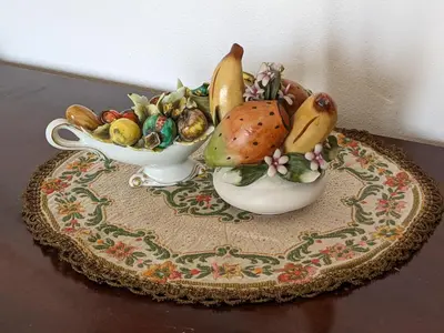 a couple of bowls of fruit on a table at Villa with private pool and wonderful view in Carini