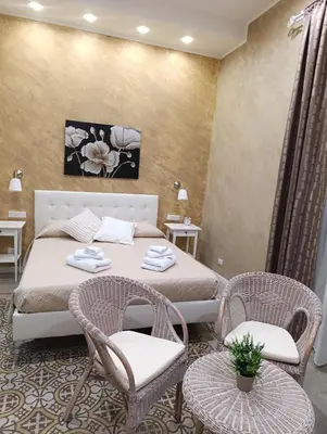 a bedroom with a bed in a room at Anninedda Rooms in Palermo