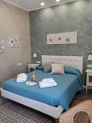 a bathroom with a shower with a blue light at Anninedda Rooms in Palermo