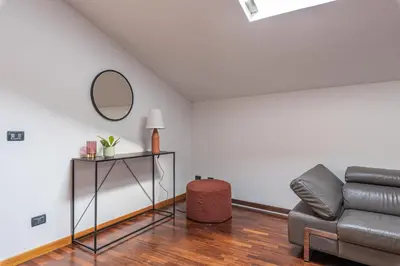 a living room with a couch and a mirror at Kadì Apartment by Wonderful Italy in Palermo
