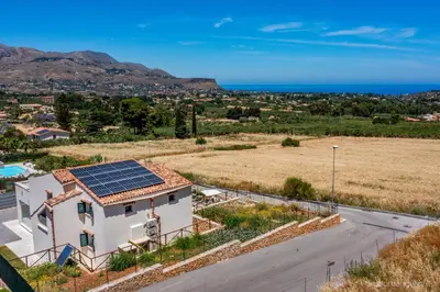 a house with solar panels on the roof at VILLA AGLEA Luxury By Sicily Home Solutions in Castellammare del Golfo