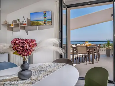 a living room with a vase of flowers on a table at Apartment Attico Dolce Vista by Interhome in Castellammare del Golfo