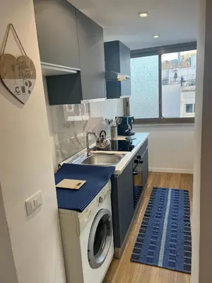 a kitchen with a sink and a washing machine at GFL Mondello - Appartamenti vista mare in Mondello