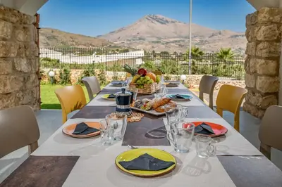 a long table with plates of food on it at Villa Hemèra Luxury By Sicily Home Solutions in Castellammare del Golfo