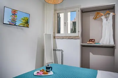 a table with a plate of food and a dress in a window at Villa Hemèra Luxury By Sicily Home Solutions in Castellammare del Golfo