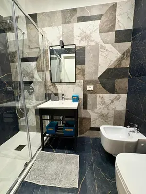 a bathroom with a sink and a mirror and a tub at Renda36 in Carini
