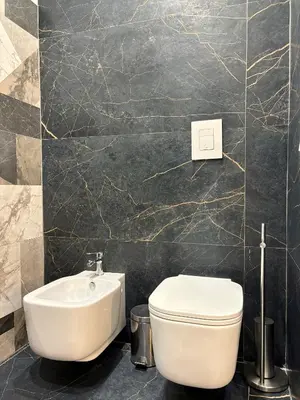 a bathroom with a white toilet and a sink at Renda36 in Carini