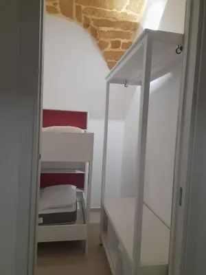 a small room with a bed and a mirror at Relaxing Room in Terrasini