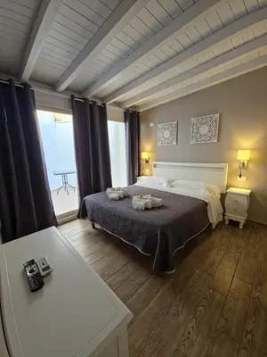 a bedroom with a bed and a large window at Hostel Josef in Palermo