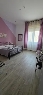a small room with a kitchen with a table and chairs at Hostel Josef in Palermo