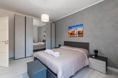 a kitchen with a dining table with a television on the wall at Casa Antonio in Palermo