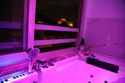 a pink bathroom with a sink and a window at Florio Suite Apartment in Palermo