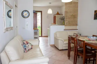 a living room with a white couch and a table at euforbia in San Vito lo Capo
