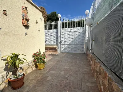 a courtyard with a fence and plants and flowers at La Perla Di Campofelice in Campofelice di Roccella