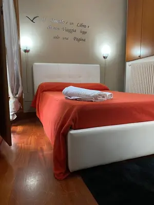 a bedroom with a bed with a red blanket at Nonno Antonio's House in Palermo