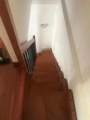 a staircase in a house with wooden floors and white walls at Nonno Antonio's House in Palermo