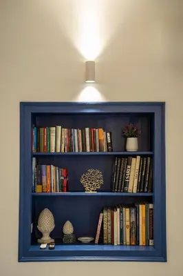 a blue book shelf with books on it at Dimora Ballarò in Palermo