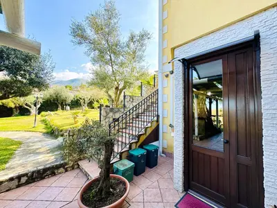 a front door of a house with a potted tree at Villa Bellavista in Carini